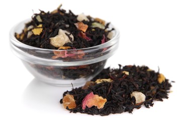 Dry black tea in bowl isolated on white
