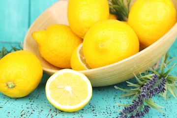 Fototapeta na wymiar Still life with fresh lemons and lavender on blue background