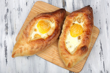 Ajarian khachapuri on wooden table close up