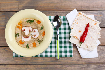 Bowl of tasty fresh hummus with mushrooms
