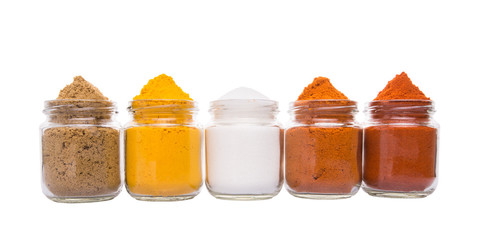 Salt and various spices over white background