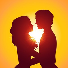 Sunset silhouettes of kissing couple