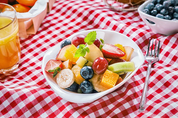 Healthy summer picnic with tropical fruit salad