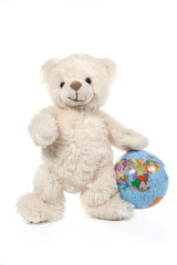 Fluffy white teddy bear with a globe on white