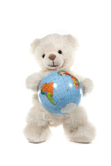 Fluffy white teddy bear with a globe on white
