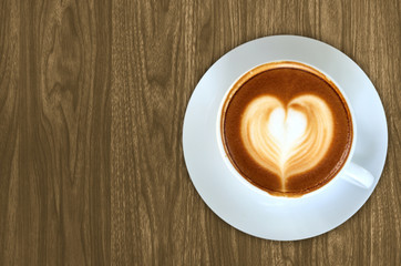 Coffee latte art on Wood background texture for design