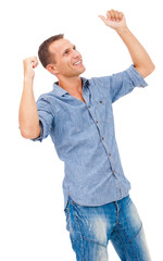 Portrait of a young man with his arms raised in celebration