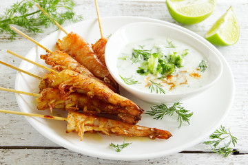 Fried prawns with sauce of yogurt and cucumber.