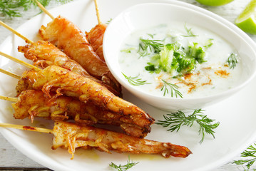Fried prawns with sauce of yogurt and cucumber.