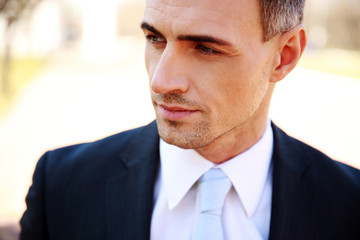 Portrait of a thoughtful businessman on the street