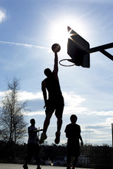 Basketball silhouette player dunking in a game