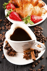 Breakfast with coffee in heart shape and croissants in a basket