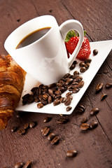 Two cups of coffee with croissants and pieces of cinnamon