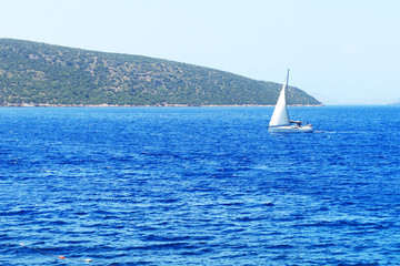 The sail yacht on turquoise water near beach, Bodrum, Turkey