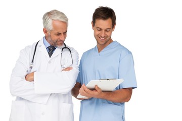 Male doctor and surgeon discussing reports