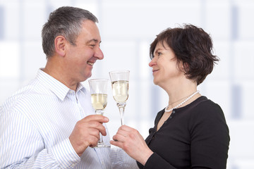 Man and woman celebrating with champagne