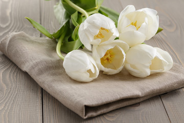 Fototapeta na wymiar white tulips on old wood table