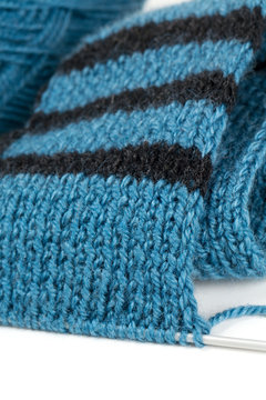 striped scarf on knitting needles