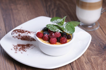 Creme brulee and coffee on a wooden table