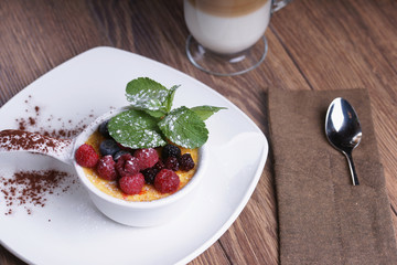 Creme brulee and coffee on a wooden table