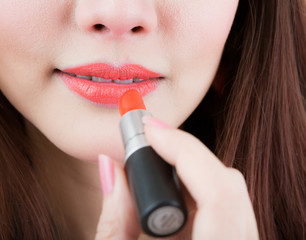 Applying makeup lipstick