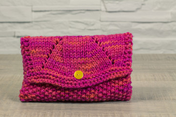 Make up case, small pink handbag knitted on a vintage table
