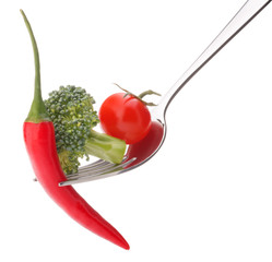 Fresh raw vegetables on fork isolated on white background cutout