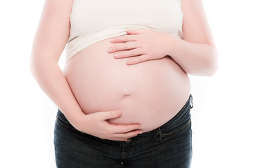 Hands of mother touching her pregnancy belly. Isolated on white.