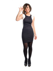 Fototapeta premium Pretty woman making Ok sign over white background