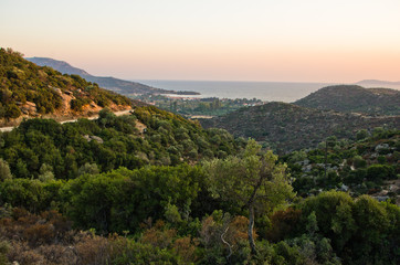 Naklejka na ściany i meble Panorama of a small greek village by the sea at sunset