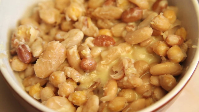 Melt cheese on mix of beans in a pot