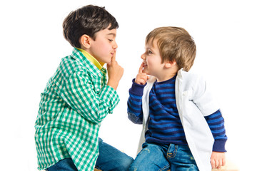 Kids doing silence gesture over white background