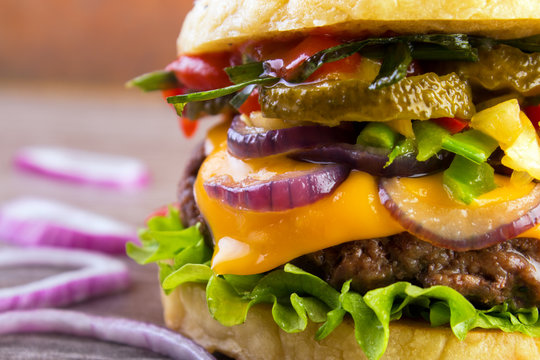 Juicy burger closeup with roasted vegetables