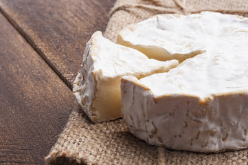 Camembert cheese slice on wooden table