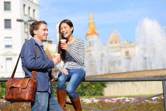Happy couple drinking coffee talking in Barcelona