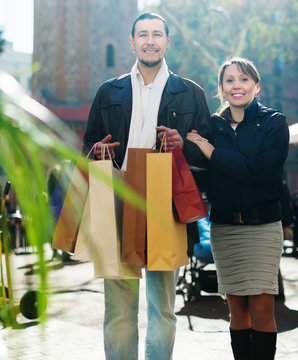 couple with shopping bags at  street