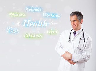 Clinical doctor pointing to health and fitness collection of wor