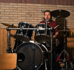 Energetic rock drummer in action. Long blonde hair. Jam session.