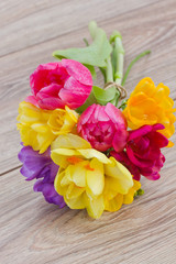 posy  of spring flowers on wooden table