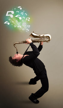 Young musician playing on saxophone while musical notes explodin