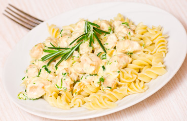 Sliced fried chicken fillet with garlic and rosemary in a creamy
