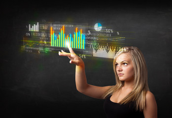 Young business woman touching colorful charts and diagrams