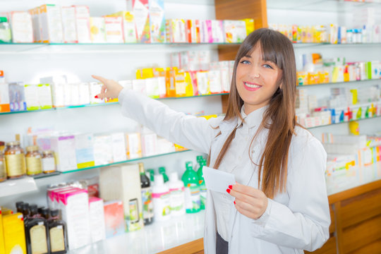 Portrait of a smiling female pharmacist with prescription