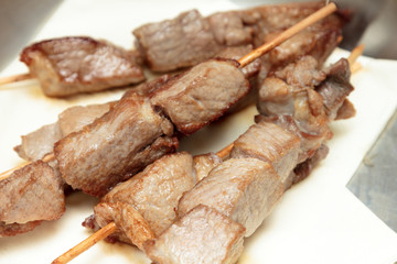 Pork skewers on napkins