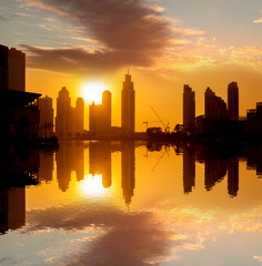 Fototapeta na wymiar Dubai city with skyscrapers against sunset United Arab Emirates