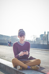 young beautiful hipster woman using smart phone