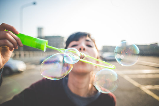 young beautiful hipster woman bubble blower