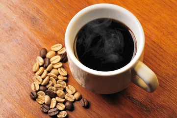 Coffee cup with grains in the wood table