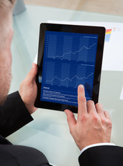 Businessman navigating on his tablet-pc