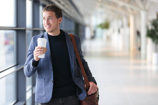 Businessman Drinking Coffee Walking In Airport